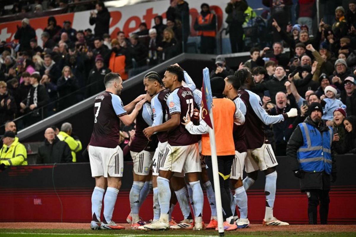 Aston Villa's English midfielder #27 Morgan Rogers celebrates with team-mates after scoring his team's first goal to take the lead 1-0 during the English Premier League football match between Aston Villa and Manchester United at Villa Park in Birmingham, central England on December 21, 2025.  Ben STANSALL / AFP