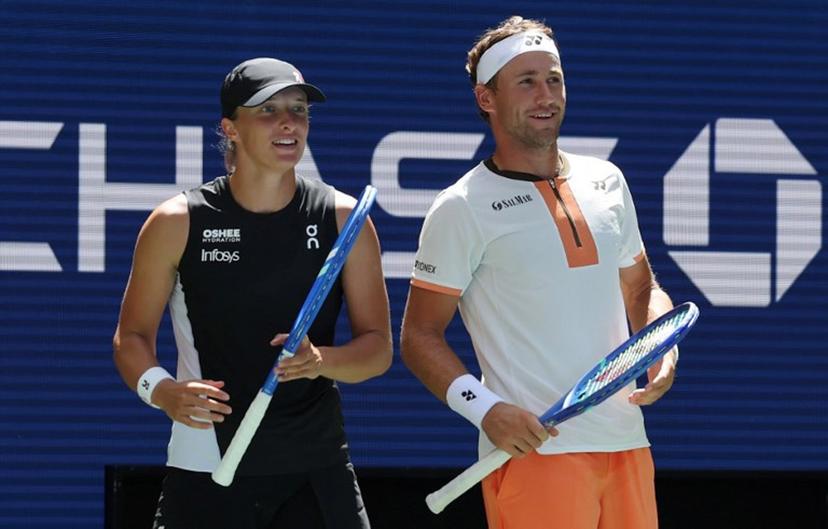 Norway's Casper Ruud (R) and Poland's Iga Swiatek react after a point against Madison Keys and Frances Tiafoe of the USA during their Mixed Doubles Match at the US Open tennis tournament at the USTA Billie Jean King National Tennis Center in New York City, on August 19, 2025.  TIMOTHY A. CLARY / AFP