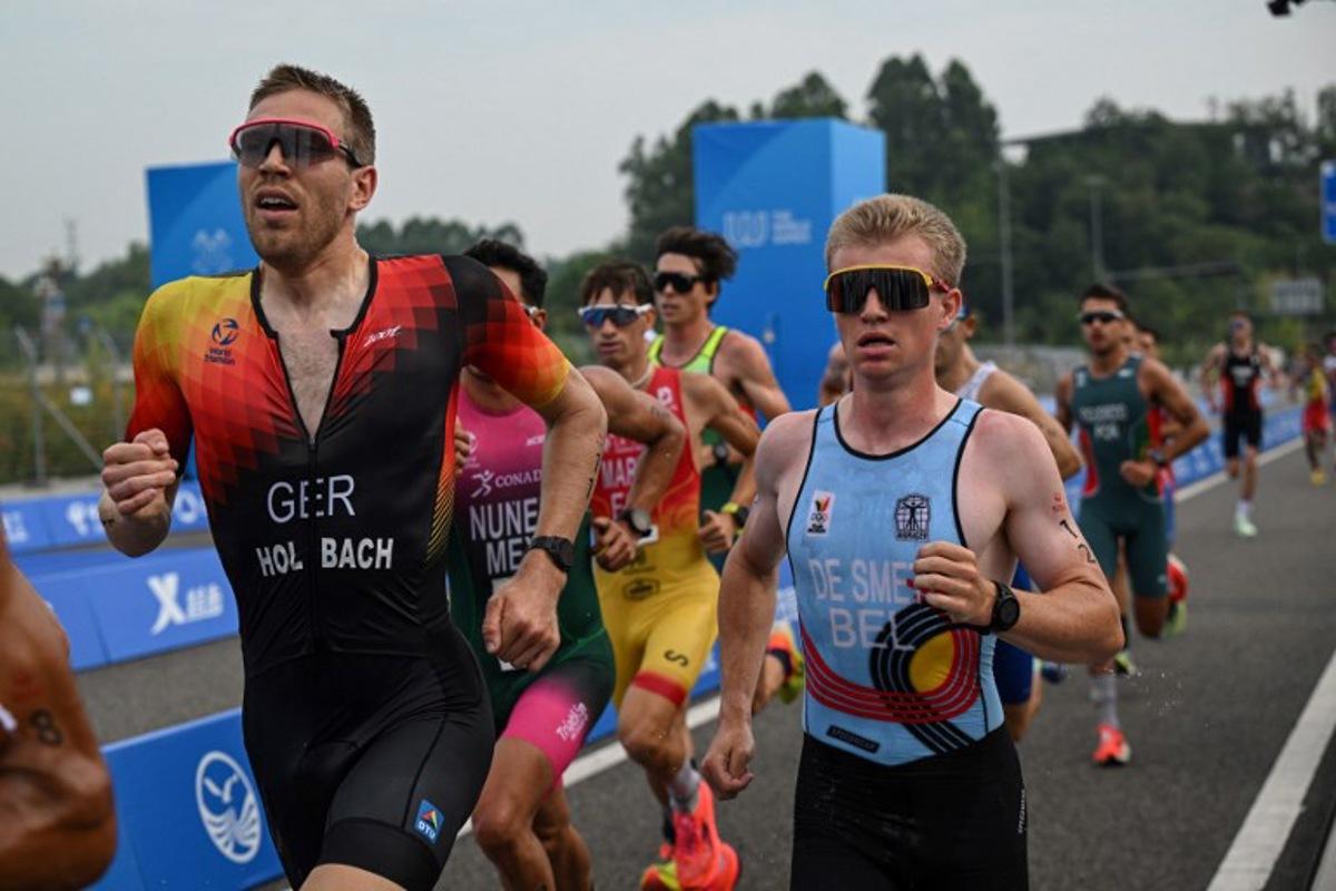 Germany's Fabian Holbach (L) and Belgium's Thibaut De Smet (R) compete in the men's individual duathlon final during the 2025 World Games at the Xinglong Lake Hubin Arena in Chengdu, in China's southwestern Sichuan province on August 14, 2025.  Jade GAO / AFP