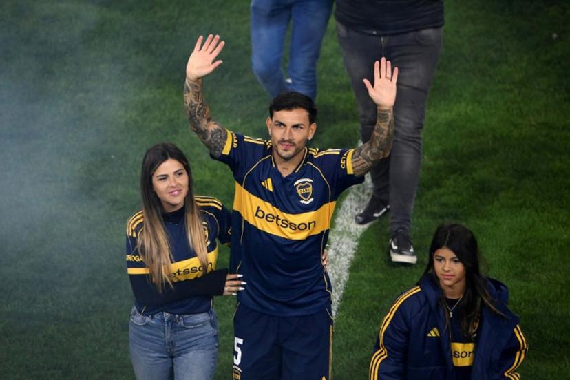 Argentina's Boca Juniors midfielder Leandro Paredes (C) waves to supporters next to his wife, Camila Galante (L), and their daughter, Victoria, during his presentation at La Bombonera Stadium in Buenos Aires on July 10, 2025. Argentine midfielder Leandro Paredes, World Cup champion in Qatar 2022, returned to Boca Juniors, the team where he began his career between 2010 and 2013, before embarking on a European tour that culminated weeks ago at AS Roma. Luis ROBAYO / AFP