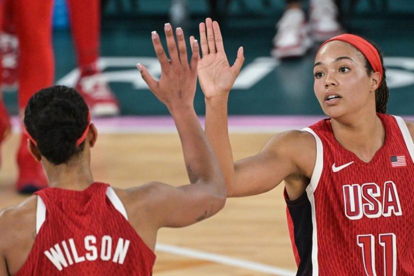 USA's #09 A'ja Wilson and USA's #11 Napheesa Collier celebrate in the women's Gold Medal basketball match between France and the USA during the Paris 2024 Olympic Games at the Bercy  Arena in Paris on August 11, 2024.  Damien MEYER / AFP