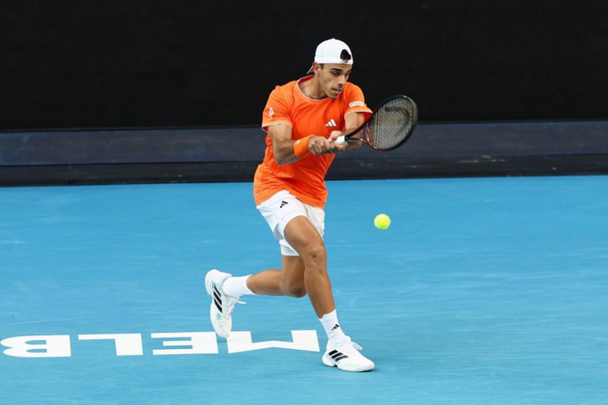Argentina's Francisco Cerundolo hits a shot against Germany's Alexander Zverev during their men's singles match on day eight of the Australian Open tennis tournament in Melbourne on January 25, 2026.  IZHAR KHAN / AFP