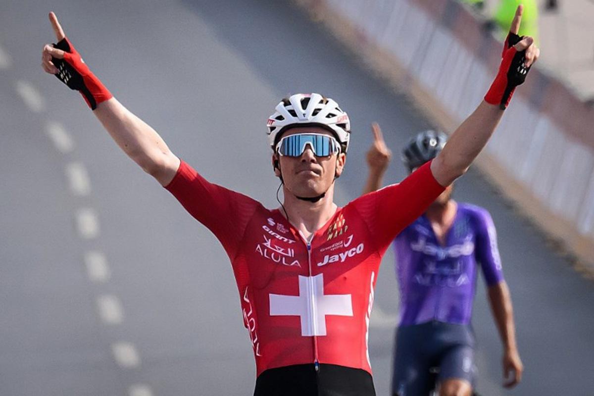 Team Jayco AlUla Swiss rider Mauro Schmid celebrates as he crosses the finish line to win the Muscat Classic cycling race in Muscat, on February 6, 2026.  Loic VENANCE / AFP