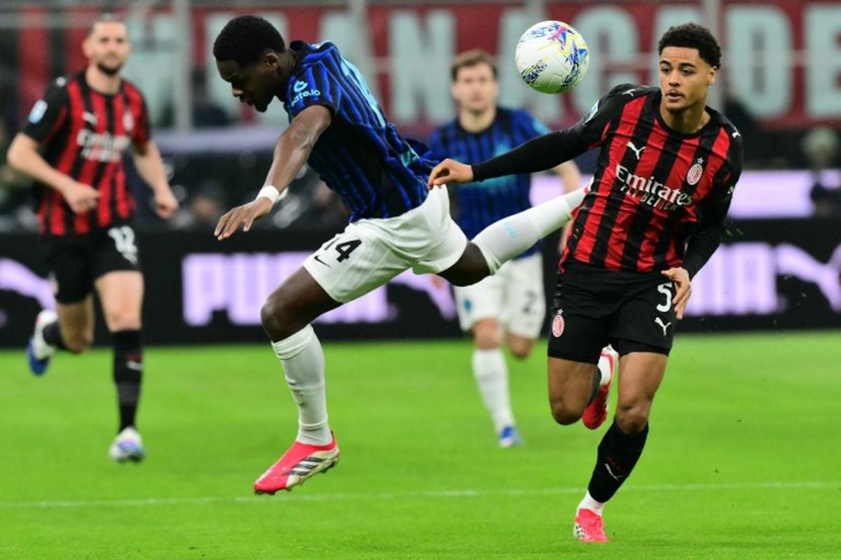 Inter Milan's French forward #14 Ange-Yoan Bonny (L) fights for the ball with AC Milan's Belgian defender #05 Koni De Winter during the Italian Serie A football match between AC Milan and Inter Milan at San Siro stadium in Milan, northern Italy, on March 8, 2026.  Stefano RELLANDINI / AFP