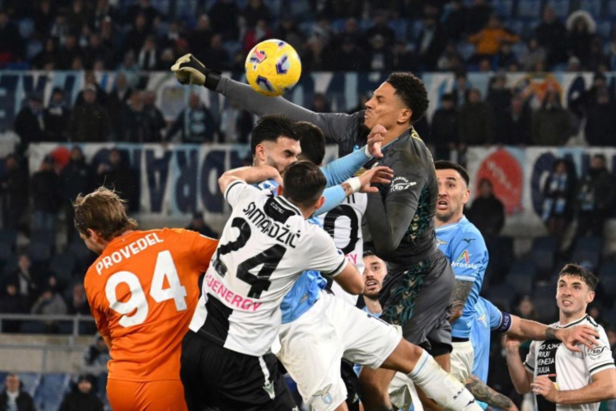 Udinese's German-Nigerian goalkeeper #40 Maduka Okoye pushes the ball during the Italian Serie A football match between Lazio and Udinese, at Olympic stadium in Rome, on March 11, 2024 .  Alberto PIZZOLI / AFP
