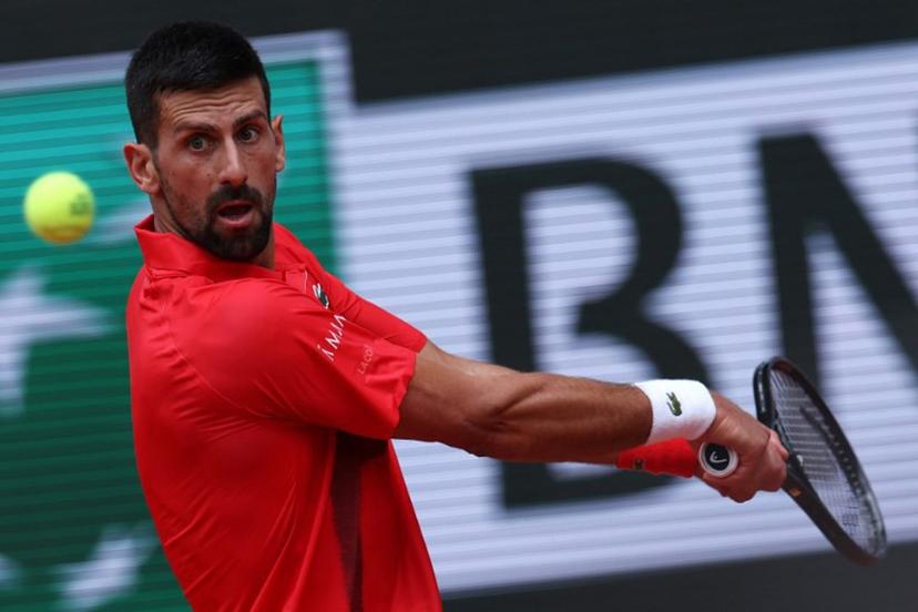 Serbia's Novak Djokovic plays a backhand return to Britain's Cameron Norrie during their men's singles match on day 9 of the French Open tennis tournament on Court Philippe-Chatrier at the Roland-Garros Complex in Paris on June 2, 2025.  Alain JOCARD / AFP