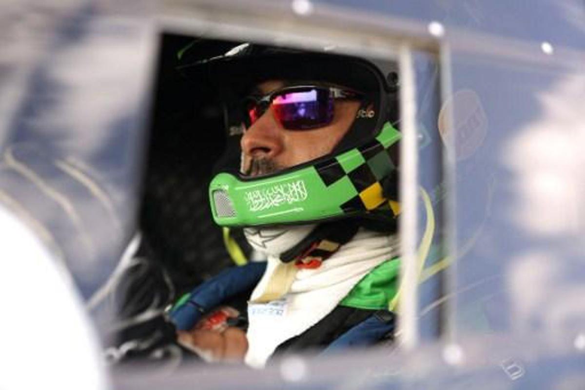 Mini team driver Saudi Yazeed Mohamed al-Rahji sits in his car wearing a helmet decorated with his country's flag after finishing in second place of the Silkway rally at the end of the 14th special stage near the town of Wuhai in Inner Mongolia on July 23, 2016. 130 competitors are racing over 10,734 kilometres crossing three countries and two continents from Moscow to Beijing.
PATRICK BAZ / AFP