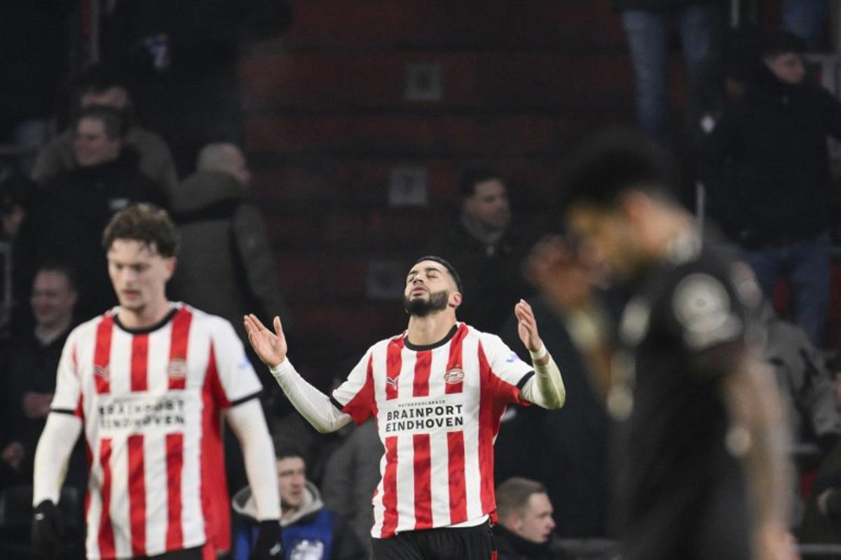PSV Eindhoven's Moroccan midfielder #34 Ismael Saibari (C) celebrates after scoring his team's first goal during the UEFA Champions League league phase day 8 football match between PSV Eindhoven and Bayern Munich at Philips Stadion in Eindhoven on January 28, 2026.  JOHN THYS / AFP
