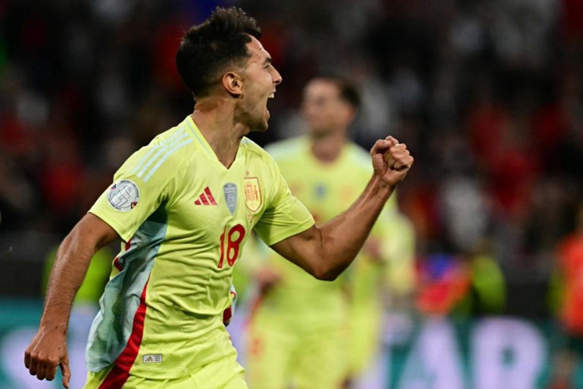 Spain's midfielder #18 Martin Zubimendi celebrates scoring the opening goal with his teammates during the UEFA Nations League final football match between Portugal and Spain in Munich, southern Germany on June 8, 2025.  Tobias SCHWARZ / AFP