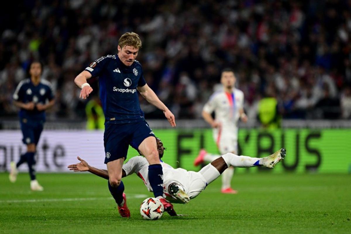 Manchester United's Danish forward #09 Rasmus Hojlund (C) fights for the ball with Lyon's Angolan defender #22 Clinton Mata between Olympique Lyonnais (OL) during the UEFA Europa League Quarter final first leg football match between Olympique Lyonnais (OL) and Manchester United at the Parc Olympique Lyonnais Groupama stadium in Decines-Charpieu, central-eastern France, on April 10, 2025.  Olivier CHASSIGNOLE / AFP
