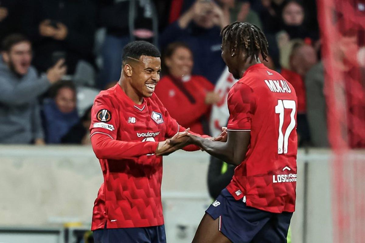 Lille's Moroccan forward #29 Hamza Igamane (L) celebrates with his teammate Lille's Congolese midfielder #17 Ngal'Ayel Mukau after scoring his team's opening goal during the UEFA Europa League 1st round day 1 football match between LOSC Lille and SK Brann at the Stade Pierre-Mauroy in Villeneuve-d'Ascq, northern France, on September 25, 2025.  Sameer Al-DOUMY / AFP