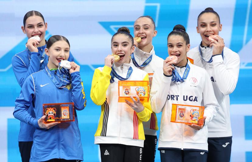 Belgian Maysae Bouhouch and Belgian Silke Macharis celebrate on the podium after winning the women's pair acrobatics gymnastics competition of the World Games 2025, in Chenghdou, China, on Friday 08 August 2025. This year, the World Games take place from 07 to 17 augustus. BELGA PHOTO VIRGINIE LEFOUR