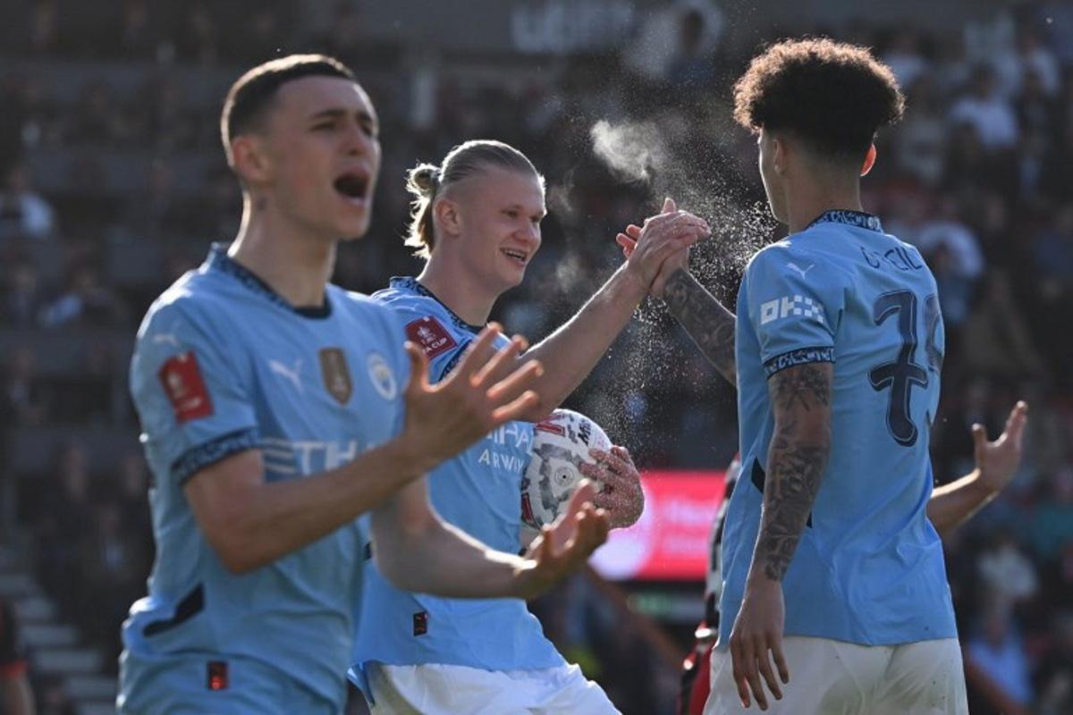 Manchester City's Norwegian striker #09 Erling Haaland (C) celebrates with Manchester City's English midfielder #75 Nico O'Reilly (R) after the two combine for their first goal during the English FA Cup quarter-final football match between Bournemouth and Manchester City at the Vitality Stadium in Bournemouth, on the south coast of England on March 30, 2025.  JUSTIN TALLIS / AFP