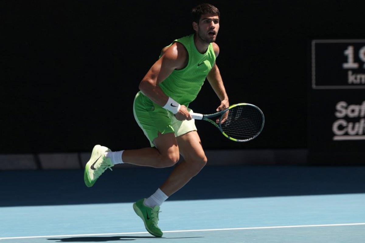 Spain's Carlos Alcaraz hits a return against USA's Tommy Paul during their men's singles match on day eight of the Australian Open tennis tournament in Melbourne on January 25, 2026.   DAVID GRAY / AFP