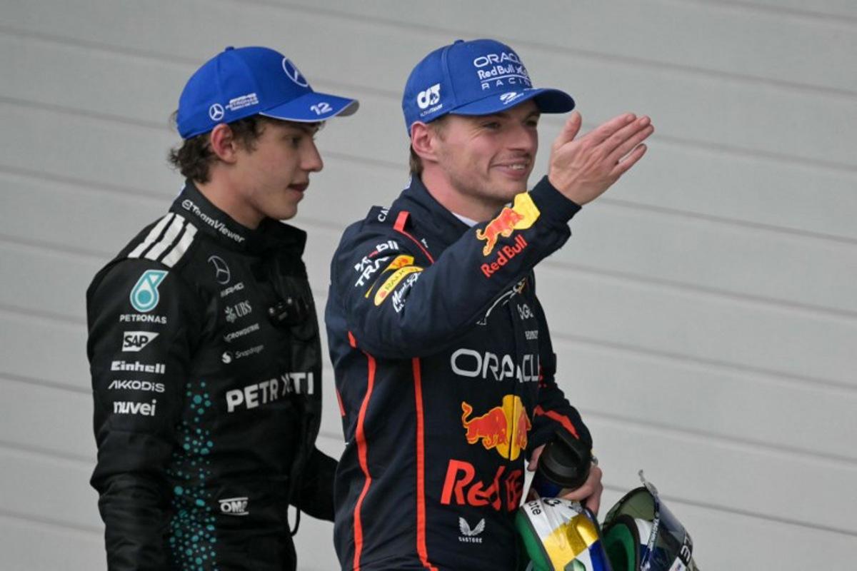 Red Bull Racing's Dutch driver Max Verstappen (R) smiles as he blows a kiss, next to Mercedes' Italian driver Kimi Antonelli (L), after getting the third place during the Sao Paulo Formula One Grand Prix at the Jose Carlos Pace racetrack, aka Interlagos, in Sao Paulo, Brazil on November 9, 2025.  Nelson ALMEIDA / AFP