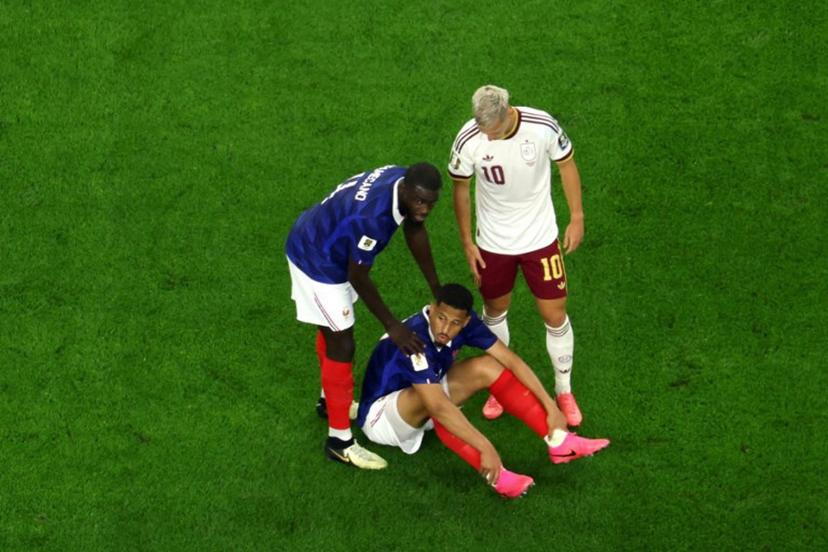 France's defender #17 William Saliba sits on the pitch surrounded by France's defender #04 Dayot Upamecano (L) and Spain's forward #10 Dani Olmo after sustaining an injury during the 2026 World Cup football tournament semi-final match between France and Spain at the Dallas Stadium in Arlington on July 14, 2026.   Odd ANDERSEN / AFP