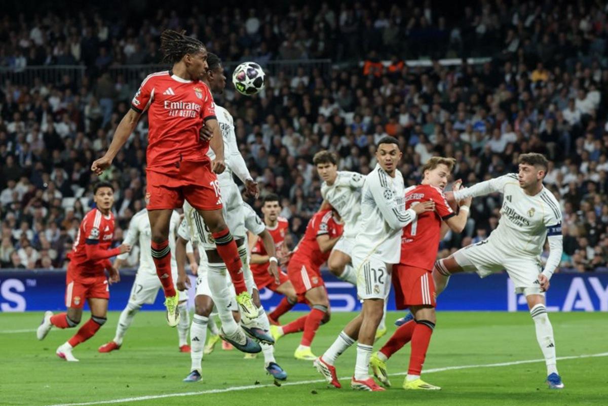 SL Benfica's Luxembourgish midfielder #18 Leandro Barreiro (L) goes for a header with Real Madrid's French midfielder #06 Eduardo Camavinga during the UEFA Champions League knockout round play-off second leg football match between Real Madrid CF and SL Benfica at Santiago Bernabeu Stadium in Madrid on February 25, 2026.  Pierre-Philippe MARCOU / AFP