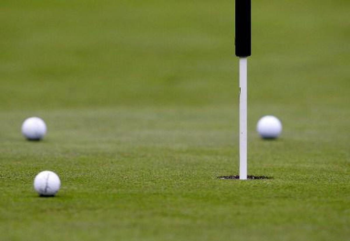 The three balls from the leaderball lies on the first green after the second shoot during the third day of play at the PGA European Tour, Scandinavian Masters in Kungsangen outside Stockholm, 30 July 2005. Of the three in the ball, Barry Lane of England and Bradley Dredge of Wales stayed in the top on -18 while Sweden's Pierre Fulke dropped to a sixth place on -13.  AFP PHOTO - SVEN NACKSTRAND