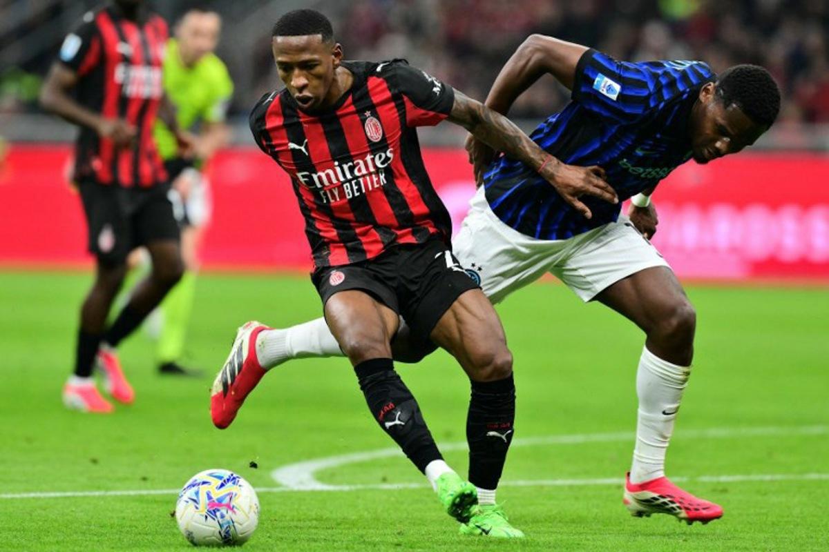 AC Milan's Ecuadorian defender #02 Pervis Estupinan (L) fights for the ball with Inter Milan's French forward #14 Ange-Yoan Bonny during the Italian Serie A football match between AC Milan and Inter Milan at San Siro stadium in Milan, northern Italy, on March 8, 2026.  Stefano RELLANDINI / AFP