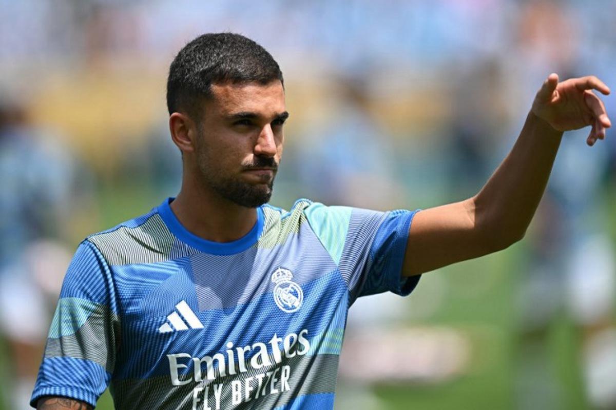 Real Madrid's Spanish midfielder #19 Dani Ceballos warms up ahead of the FIFA Club World Cup 2025 Group H football match between Spain's Real Madrid and Mexico's Pachuca at the Bank of America stadium in Charlotte on June 22, 2025.  Paul ELLIS / AFP