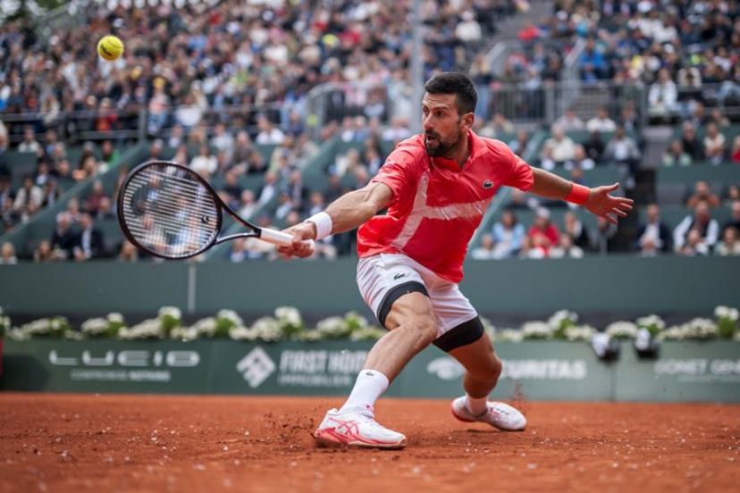 Serbia's Novak Djokovic returns a ball to Hungary's Marton Fucsovics during their match at the ATP 250 Geneva Open tennis tournament in Geneva on May 21, 2025.   FABRICE COFFRINI / AFP
