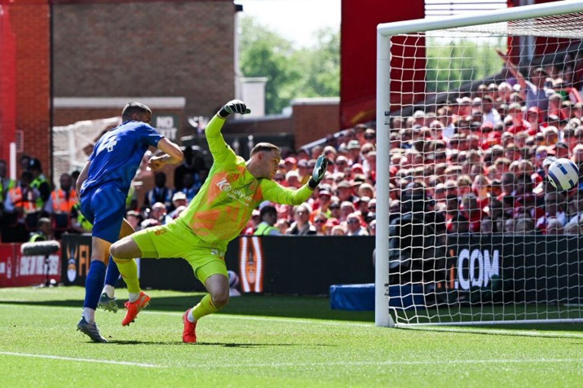 Leicester City's English defender #04 Conor Coady heads the ball and scores his team first goal past Nottingham Forest's Belgian goalkeeper #26 Matz Sels during the English Premier League football match between Nottingham Forest and Leicester City at The City Ground in Nottingham, central England, on May 11, 2025.  JUSTIN TALLIS / AFP