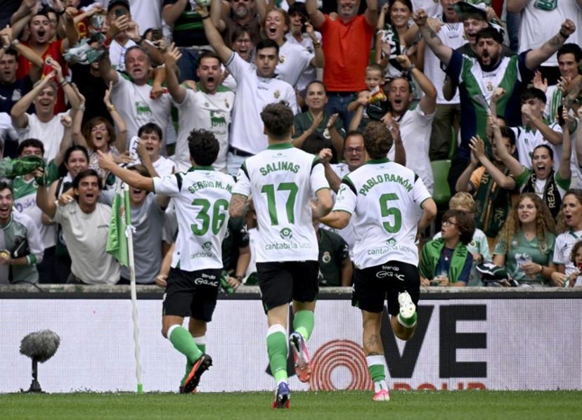 Racing Santander's Spanish midfielder #36 Sergio Martinez Montero celebrates with supporters scoring his team's second goal during the Spanish league football match between Racing Santander and Villarreal in El Sardinero stadium in Santander on August 16, 2026.  ANDER GILLENEA / AFP