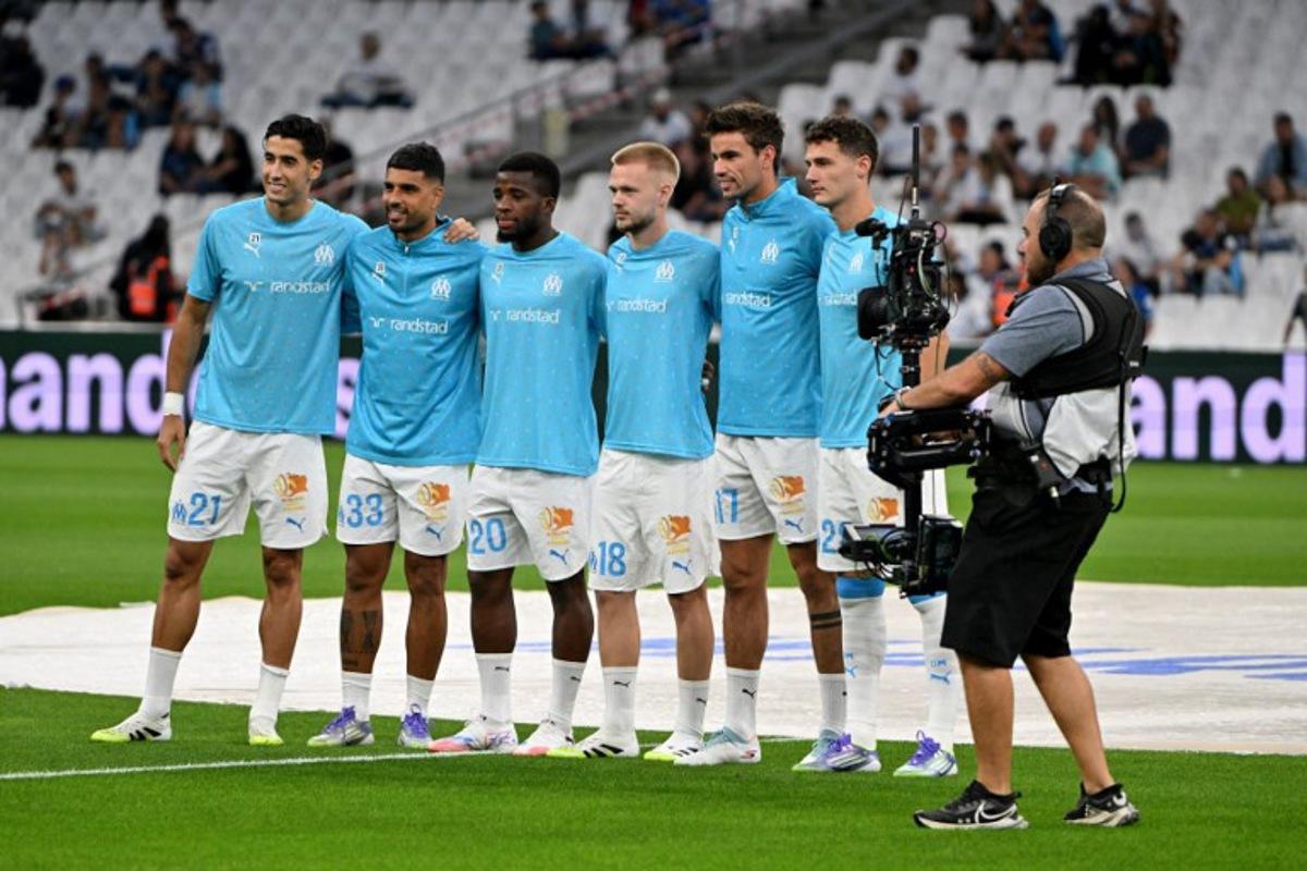 Marseilles new players (From L) Marseille's Maroccan defender #21 Nayef Aguerd, Marseille's Italian defender #33 Emerson Palmieri, Marseille's Ivorian midfielder #20 Hamed Junior Traore, Marseille's Belgian midfielder #18 Arthur Vermeeren, Marseille's Danish midfielder #17 Matt O'Riley and Marseille's  French defender #28 Benjamin Pavard pose prior to the French L1 football match between Olympique de Marseille (OM) and FC Lorient at the Stade Velodrome in Marseille, southern France on September 12, 2025.  Christophe Simon / AFP