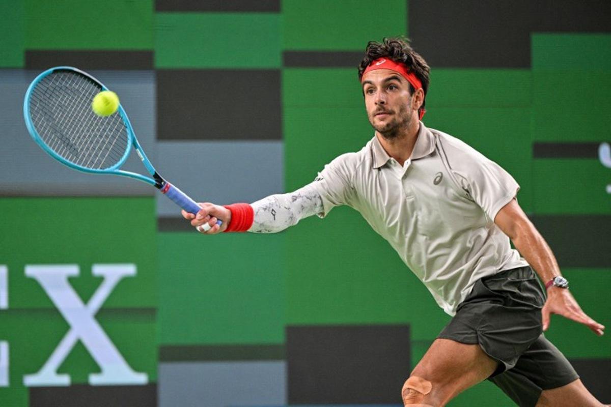 Italy's Lorenzo Musetti hits a return to China's Yi Zhou during their men's singles match at the Shanghai Masters tennis tournament in Shanghai on October 9, 2026.  Hector RETAMAL / AFP