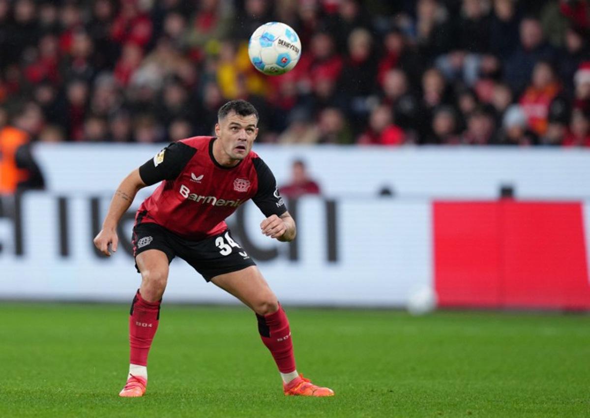 Bayer Leverkusen's Swiss midfielder #34 Granit Xhaka eyes the ball during the German first division Bundesliga football match between Bayer Leverkusen and SC Freiburg in Leverkusen on December 21, 2024.  Pau BARRENA / AFP