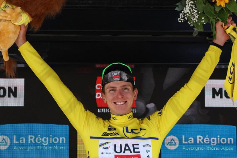 UAE Team Emirates XRG's Slovenian rider Tadej Pogačar celebrates wearing the overall leader's yellow jersey on the podium of the 1st stage of the 77th edition of the Criterium du Dauphine cycling race, 195,8 km between Domérat and Montlucon, on June 8, 2025.  Anne-Christine POUJOULAT / AFP