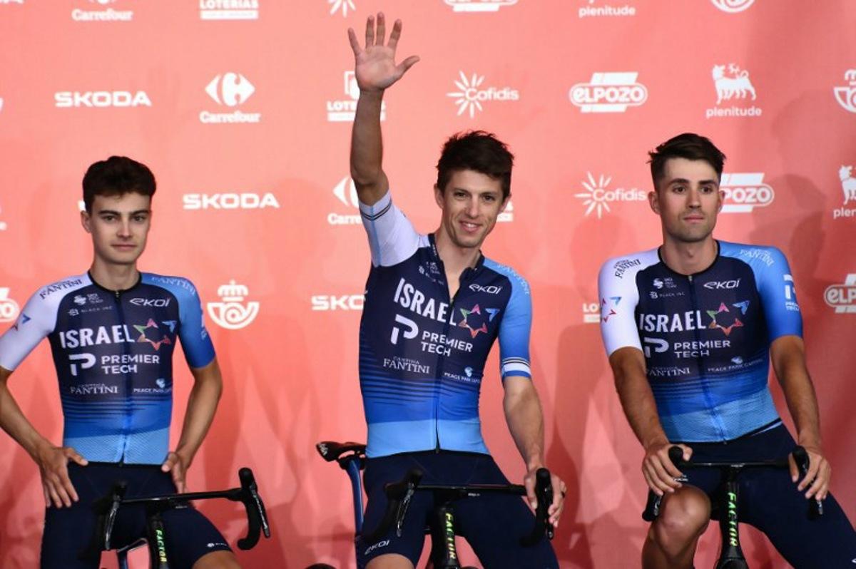 Team Israel Premier Tech 's New Zealander rider George Bennett waves from stage during the official teams presentation of the 80th edition of 'La Vuelta' cycling tour of Spain, in Torino, Italy on August 21, 2025.  Marco BERTORELLO / AFP