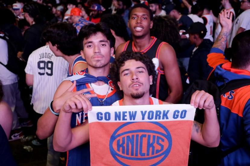 New York Knicks fans celebrate after their team won game 6 of the NBA playoffs against the reigning champions Boston Celtics outside Madison Square Garden in New York on May 16, 2025.  Leonardo Munoz / AFP