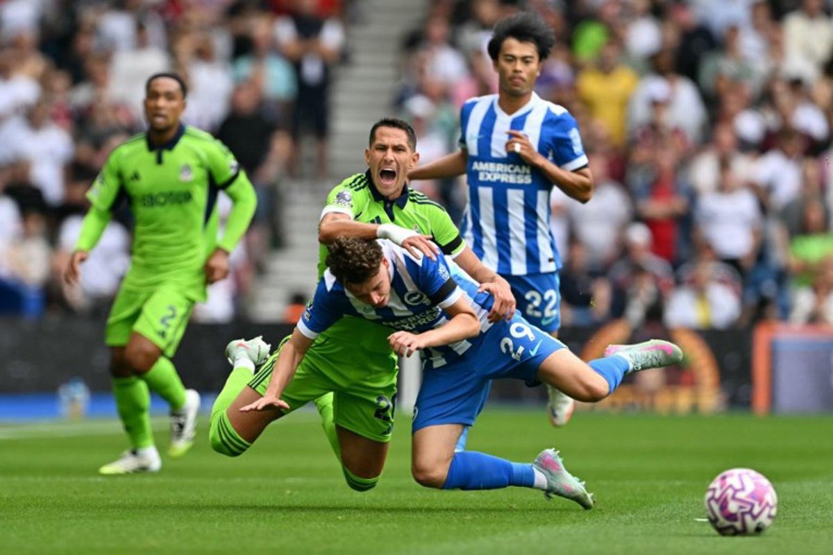 Brighton's Belgian defender #29 Maxim De Cuyper (R) and Fulham's Serbian midfielder #20 Sasa Lukic (L) go down challenging for the ball during the English Premier League football match between Brighton and Hove Albion and Fulham at the American Express Community Stadium in Brighton, southern England on August 16, 2025.  Glyn KIRK / AFP