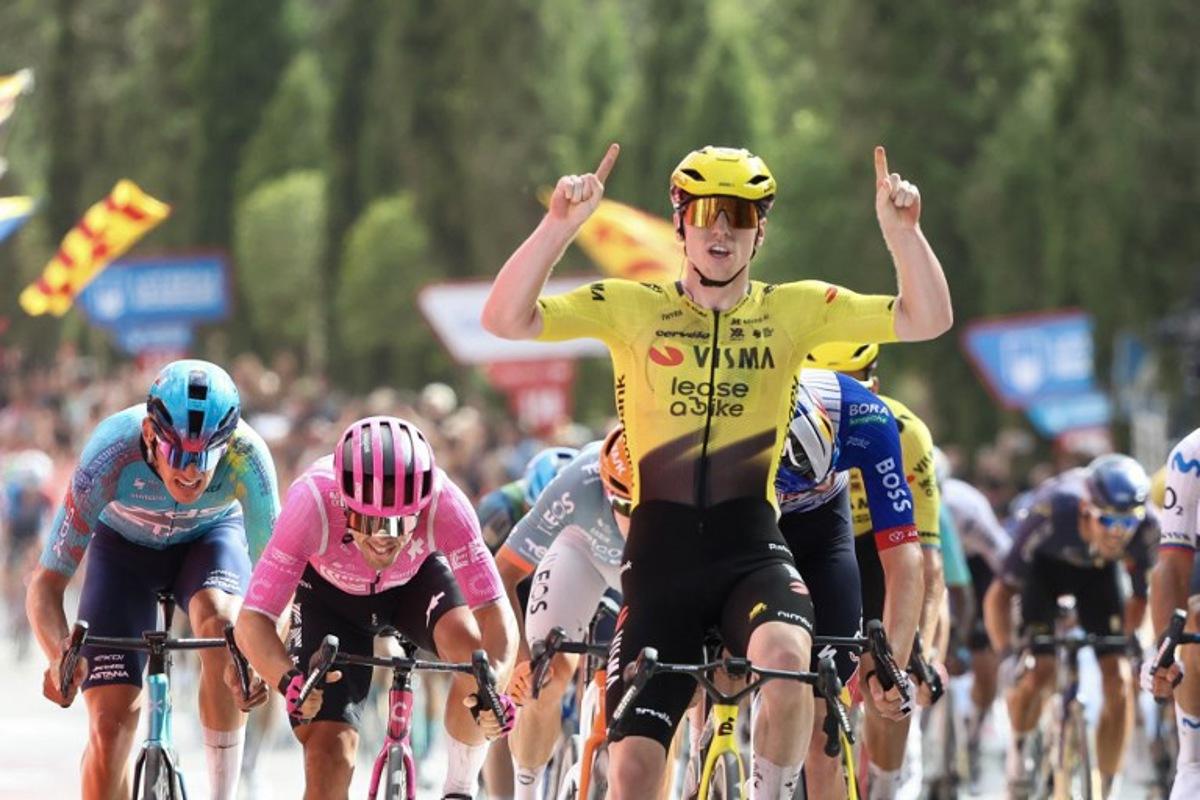 Team Visma-Lease a bike's British rider Matthew Brennan celebrates as he crosses the finish line to win the fifth stage of the Vuelta a Espana 2026, a 173,4 km race between Falset and Roquetes on August 26, 2026.    Josep LAGO / AFP