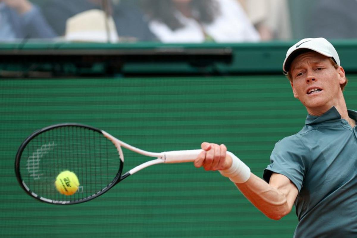 Italy's Jannik Sinner plays a forehand return to Spain's Carlos Alcaraz during the Monte Carlo ATP Masters Series Tournament final tennis match on Court Rainier III at the Monte-Carlo Country Club in Roquebrune-Cap-Martin, south-eastern France on April 12, 2026.  Valery HACHE / AFP