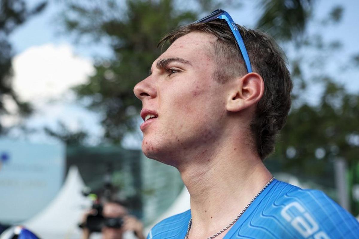Italian rider Lorenzo Mark Finn reacts after winning the men's U23 road race cycling event during the UCI 2025 Road World Championships, in Kigali, on September 26, 2025.  Anne-Christine POUJOULAT / AFP