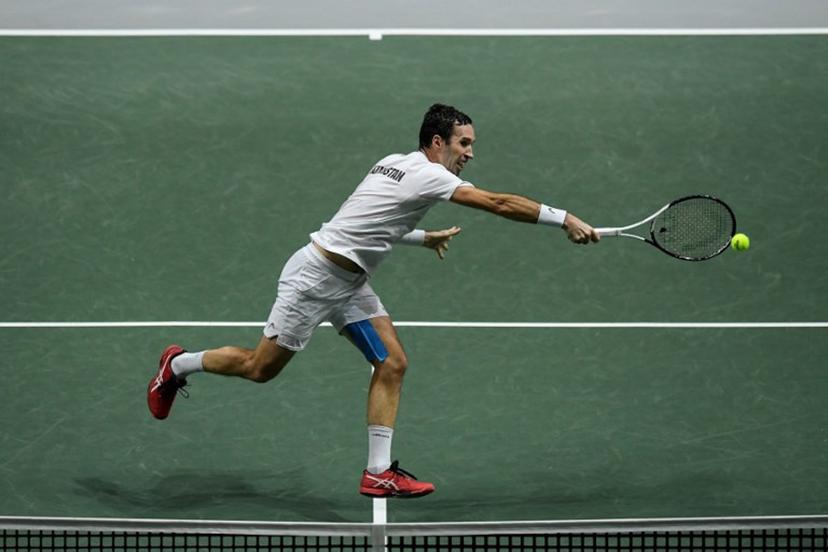Kazakhstan's Mikhail Kukushkin returns the ball to Serbia's Miomir Kecmanovic during the men's singles quarter-final tennis match between Serbia and Kazakhstan of the Davis Cup tennis tournament at the Madrid arena in Madrid on December 1, 2021.  OSCAR DEL POZO / AFP