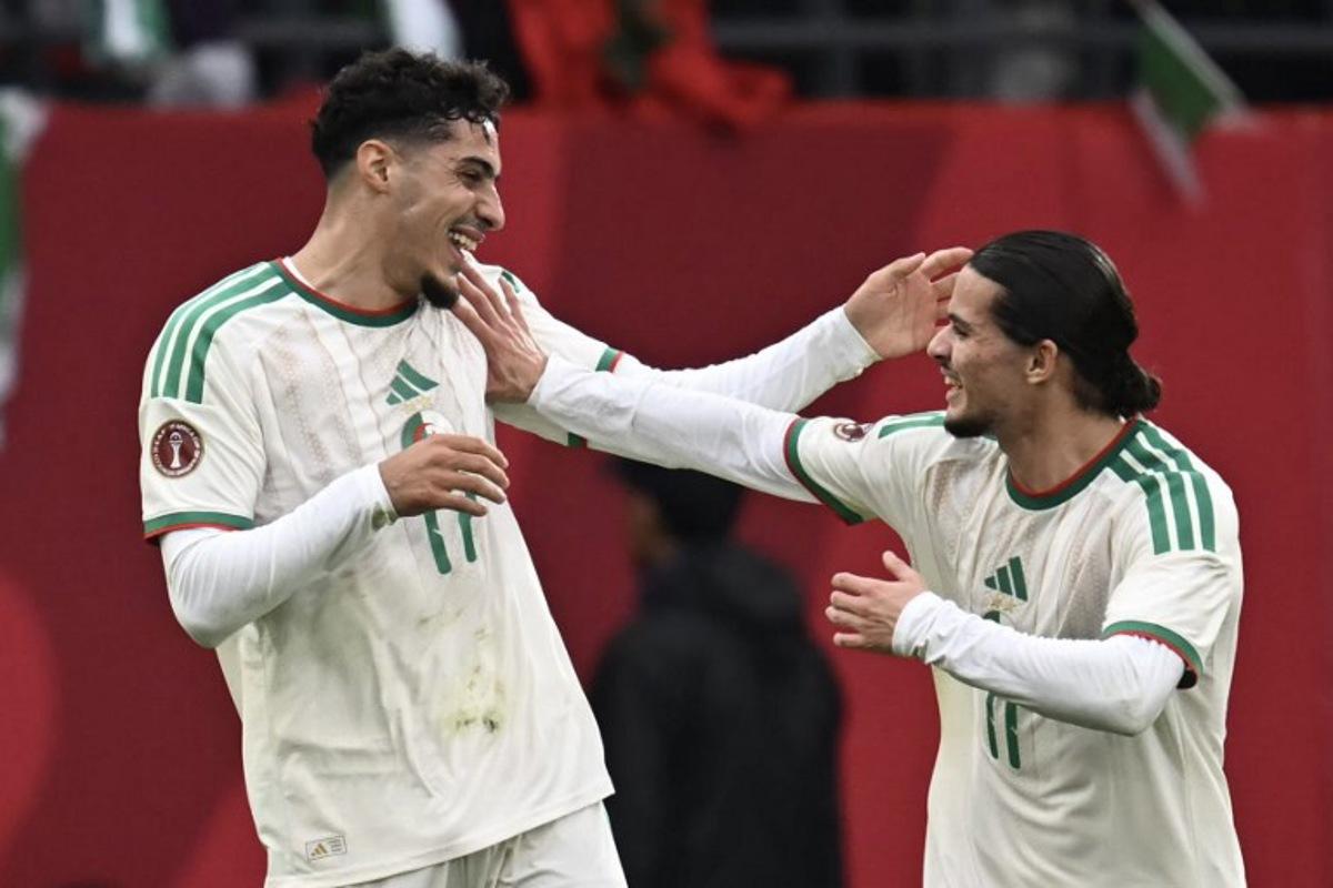 Algeria's midfielder #17 Fares Chaibi (L) celebrates scoring his team's second goal with Algeria's forward #11 Anis Hadj Moussa (R) during the Africa Cup of Nations (CAN) Group E football match between Equatorial Guinea and Algeria at Moulay Hassan Stadium in Rabat on December 31, 2025.   Paul ELLIS / AFP