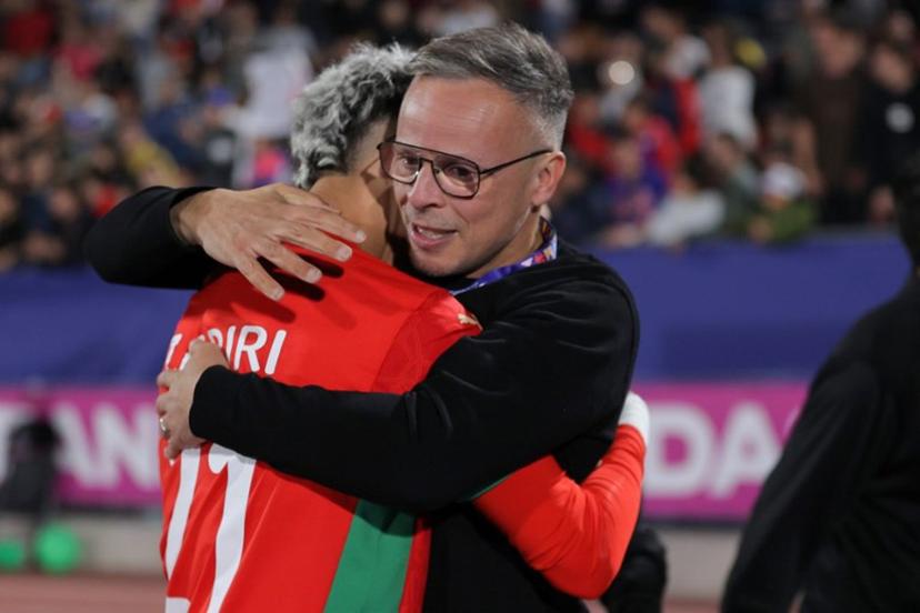 Morocco's head coach Mohamed Ouahbi and forward #21 Yassir Zabiri celebrate after winning the 2025 FIFA U-20 World Cup final football match between Argentina and Morocco at the National Stadium in Santiago on October 19, 2025.  Javier TORRES / AFP