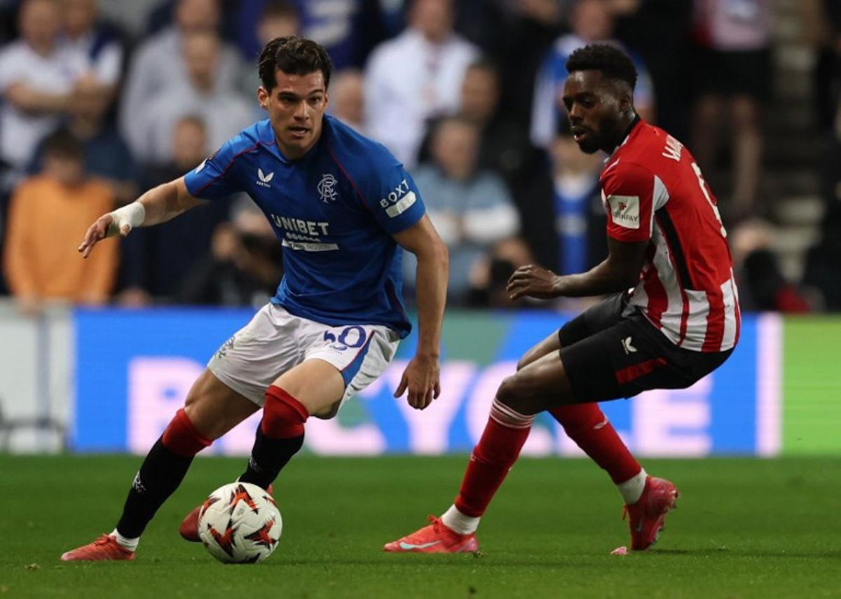 Athletic Bilbao's Spanish striker #09 Inaki Williams (R) vies with Rangers' Romanian midfielder #30 Ianis Hagi during the UEFA Europa League quarter final football match between Rangers and Athletic Club Bilbao at the Ibrox Stadium in Glasgow on April 10, 2025.  Ewan Bootman / AFP