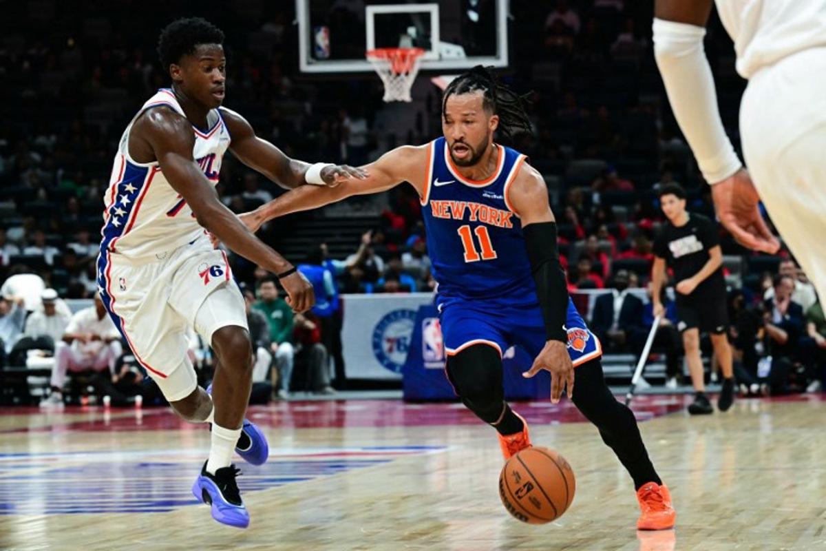 New York Knicks' #11 Jalen Brunson dribbles against Philadelphia 76ers' #77 VJ Edgecombe during the NBA basketball game between the New York Knicks and the Philadelphia 76ers at the Etihad Arena in Abu Dhabi on October 2, 2025.  Giuseppe CACACE / AFP