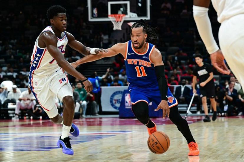 New York Knicks' #11 Jalen Brunson dribbles against Philadelphia 76ers' #77 VJ Edgecombe during the NBA basketball game between the New York Knicks and the Philadelphia 76ers at the Etihad Arena in Abu Dhabi on October 2, 2025.  Giuseppe CACACE / AFP