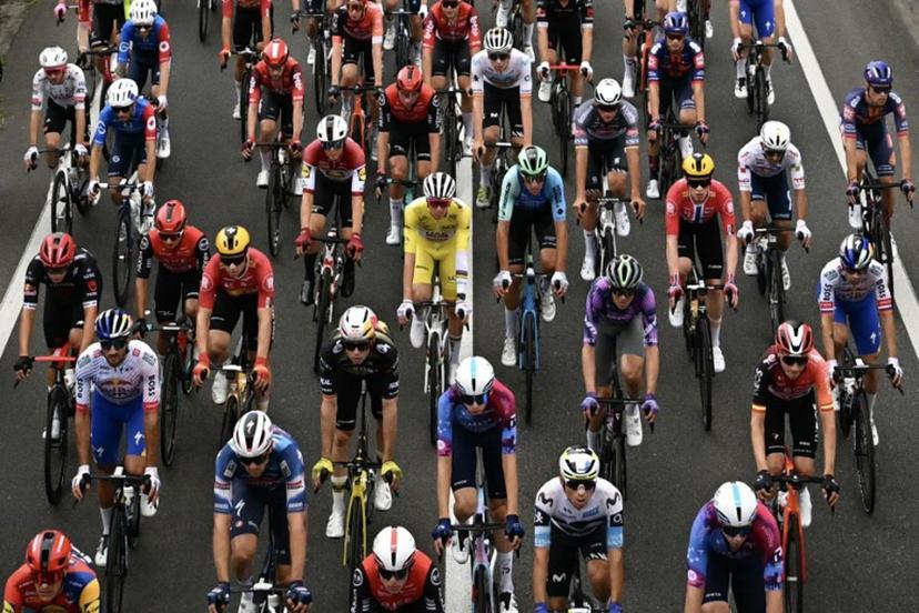 UAE Team Emirates - XRG team's Slovenian rider Tadej Pogacar wearing the overall leader's yellow jersey cycles with the pack of riders (peloton) during the 14th stage of the 112th edition of the Tour de France cycling race, 182.6 km between Pau and Luchon-Superbagneres, in the Pyrenees mountains of southwestern France, on July 19, 2025.  Loic VENANCE / AFP