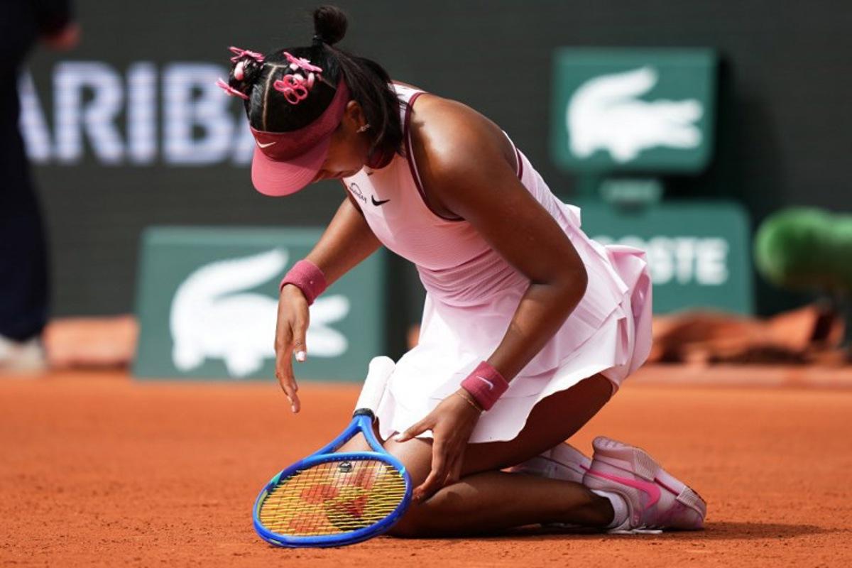 Japan's Naomi Osaka looks at her hand during her women's singles match against Spain's Paula Badosa on day 2 of the French Open tennis tournament on Court Philippe-Chatrier at the Roland-Garros Complex in Paris on May 26, 2025.  Dimitar DILKOFF / AFP