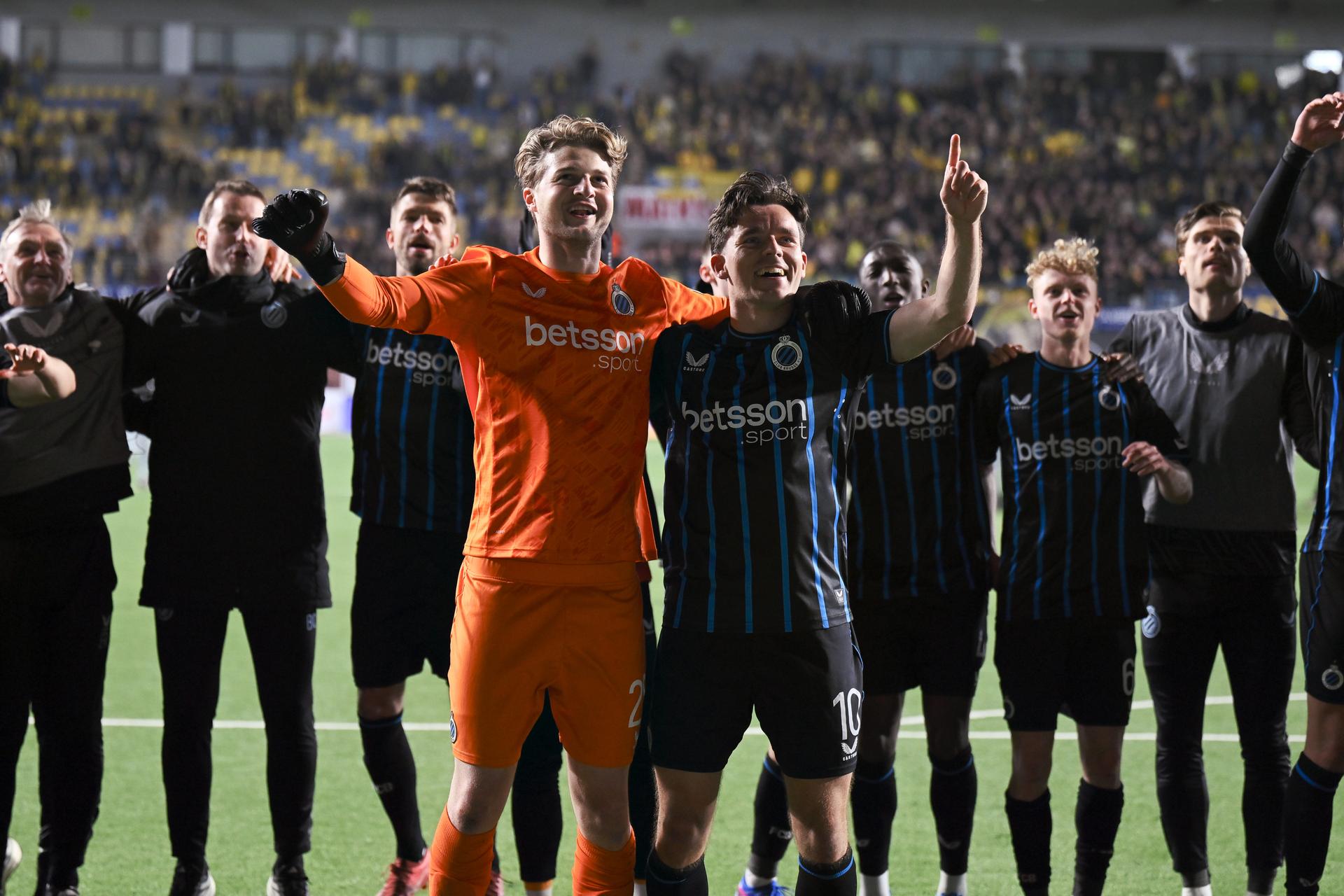 Club's goalkeeper Nordin Jackers and Club's Hugo Vetlesen celebrate after winning a soccer match between Sint-Truiden VV and Club Brugge, Saturday 11 April 2026 in Sint-Truiden, on the second day of the Champion's Play-offs of the 2025-2026 'Jupiler Pro League' first division of the Belgian championship. BELGA PHOTO JOHAN EYCKENS
