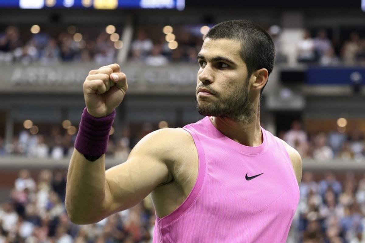 Spain's Carlos Alcaraz rects after a point against Italy's Jannik Sinner during the men's singles final tennis match on day fifteen of the US Open tennis tournament at the USTA Billie Jean King National Tennis Center in New York City on September 7, 2025.  CHARLY TRIBALLEAU / AFP
