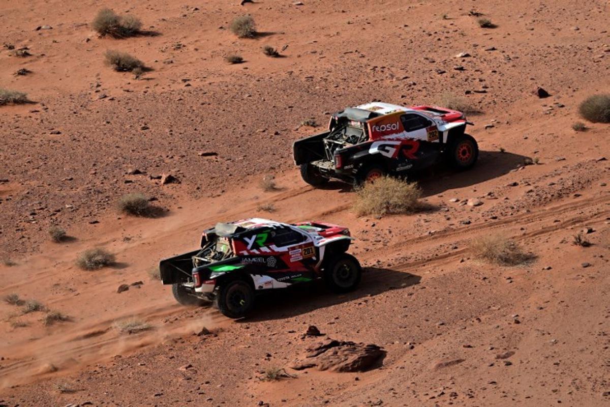 Overdrive Racing's Saudi driver Yazeed al-Rajhi and German co-driver Timo Gottschalk (left) prepare to overtake Toyota Gazoo Racing W2RC's South African driver Henk Lategan and South African co-driver Breet Cummings during the Stage 3 of the 48th edition of the Dakar Rally, between Al-Ula and Al-Ula in Saudi Arabia, on January 6, 2026.  Giuseppe CACACE / AFP