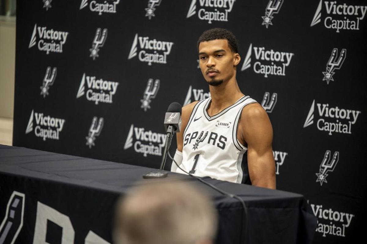 French basketball player Victor Wembanyama speaks to journalists during the San Antonio Spurs media day at the Victory Capital Performance Center in San Antonio, Texas on September 29, 2025. Wembanyama has been cleared by the team's medical staff to play for the upcoming season. SERGIO FLORES / AFP