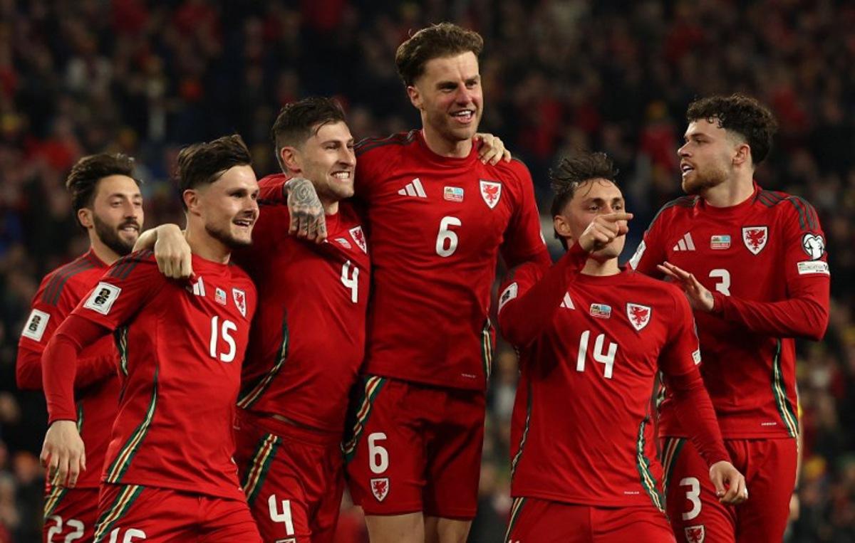 Wales' defender #04 Ben Davies (3L) celebrates scoring the team's second goal during the 2026 World Cup Group J qualifier football match between Wales and Kazakhstan, at Cardiff City Stadium, in Cardiff, on March 22, 2025.   Adrian Dennis / AFP
